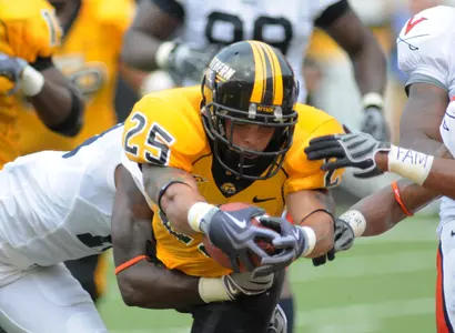 Southern Mississippi running back Damion Fletcher (25) leaps into the end zone while in the grasp of Virginia cornerback Ras-l Dowling. behind, in the second quarter of an NCAA football game in Hattiesburg, Miss., Saturday, Sept. 19, 2009.