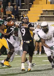 Nick Mullens evades pressure to throw the ball.