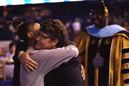 Joye Lee-McNelis congratulates Jamierra Faulkner on receiving her diploma on Sunday.