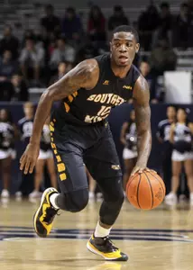 Keljin Blevins brings the ball up the court.