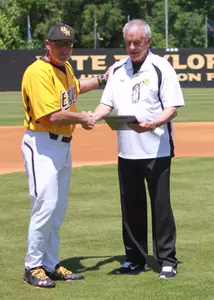 Current coach Scott Berry gives former skipper Hill Denson a plaque in celebration of the 1990 team's 25-year reunion.