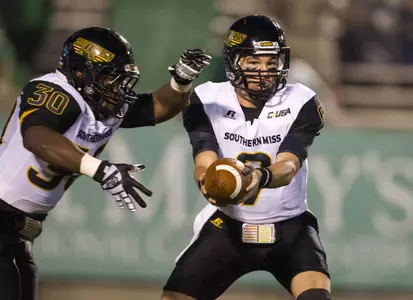 Golden Eagles quarterback Nick Mullens hands the ball off to Southern Miss Golden Eagles running back Jalen Richard during the first quarter against the Marshall Thundering Herd at Joan C. Edwards Stadium. Credit: Ben Queen-USA TODAY Sports