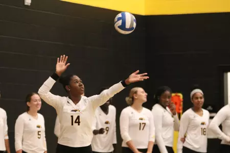 Aliah Giroux (14) serves against Troy