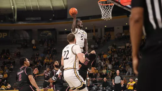 Southern Miss Golden Eagles forward DeAndre Pinckney (5) driving hard to the basket and scoring in a game between the Southern Miss Golden Eagles and the Troy Trojans. December 29, 2022 (Joe Harper/bgnphoto.com)