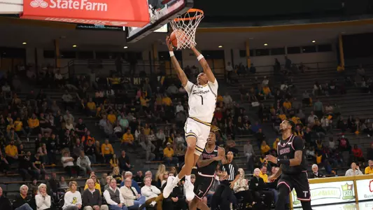 Southern Miss Golden Eagles guard Austin Crowley (1) with a fast break layup in a game between the Southern Miss Golden Eagles and the Troy Trojans. December 29, 2022 (Joe Harper/bgnphoto.com)