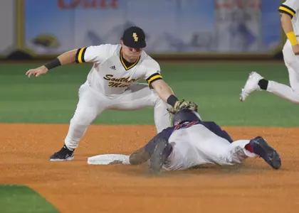 Southern Miss. infielder Will McGillis (6) tags out South Alabama outfielder Miles Simington (13) during a steal attempt in a game against South Alabama. Tuesday Feb 20, 2022  (Photo by Joe Harper/BigGold Photography)
