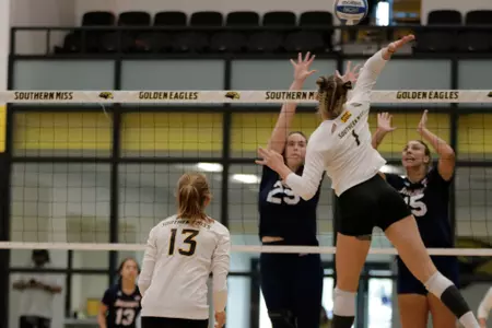 Cara Atkinson (1) delivers a kill against South Alabama