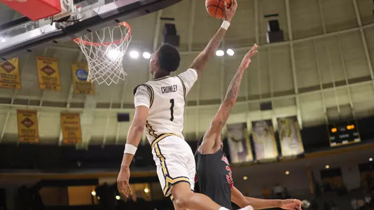 Southern Miss Golden Eagles guard Austin Crowley (1) goes for the slam dunk after the assist from Southern Miss Golden Eagles guard Neftali Alvarez (2) in a game between the Southern Miss Golden Eagles and the Arkansas State Red Wolves . January 26, 2023 (Joe Harper/bgnphoto.com)