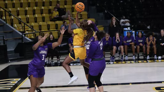 Southern Miss Lady Eagles guard Jacorriah Bracey (3) splits two James Madison defenders for a layup in a game between the Southern Miss Golden Eagles and the James Madison Monarchs . January 05, 2023 (Joe Harper/bgnphoto.com)