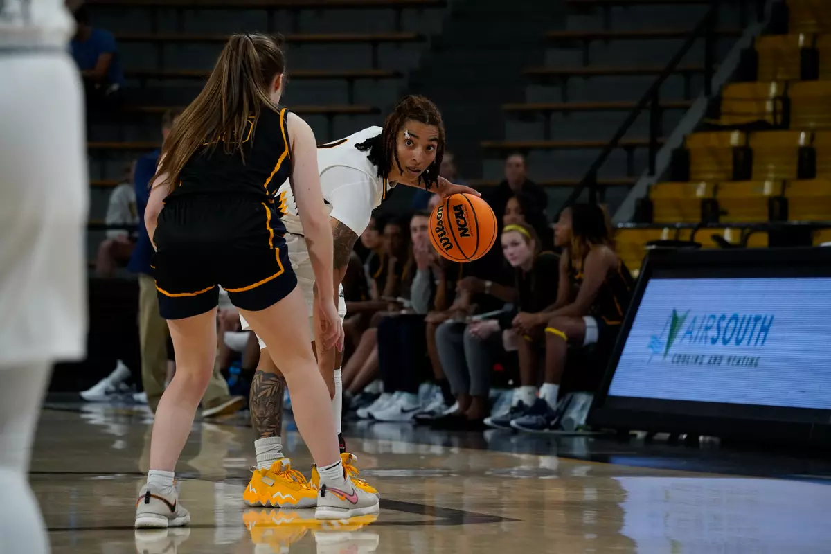 (2) Domonique Davis looks for an opening in the defense
