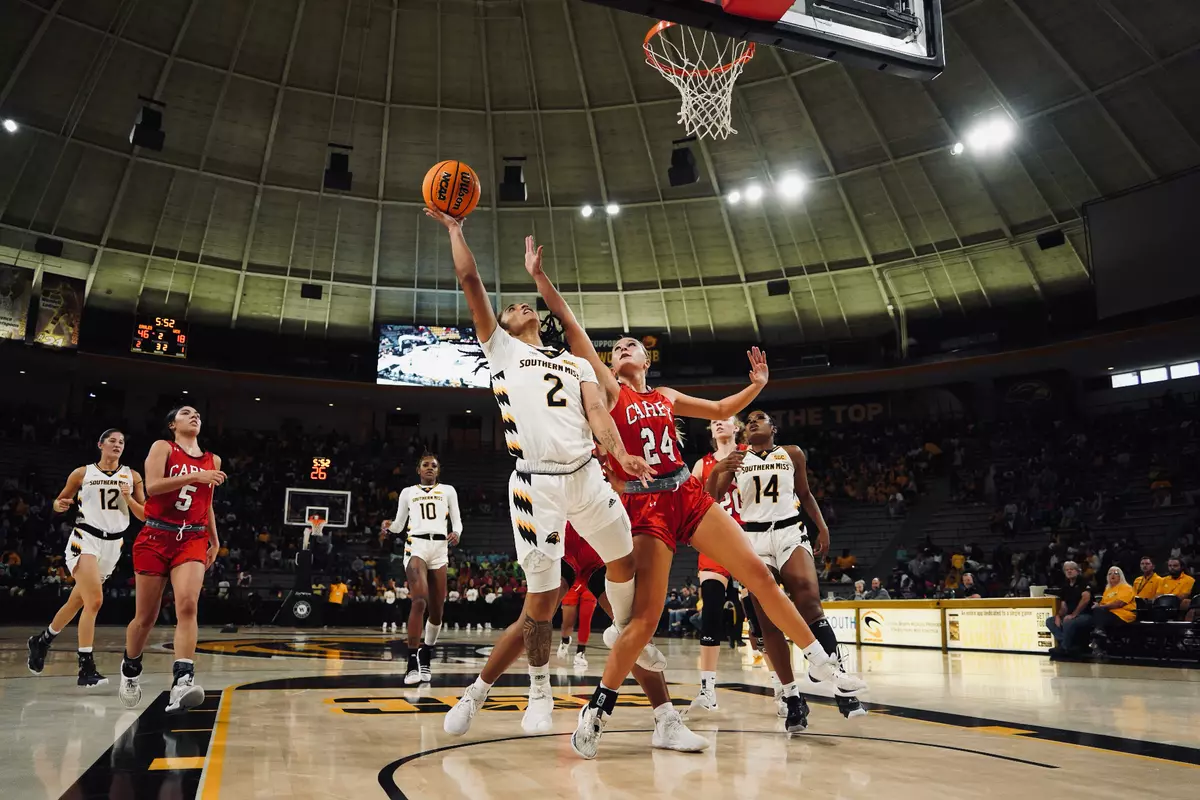 (2) Domonique Davis makes a floating layup over a Lady Crusader defender
