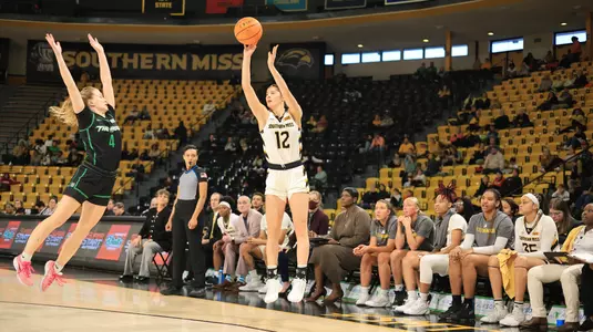 Southern Miss Lady Eagles guard Morgan Sieper (12) shoots a three point shot in a game between the Southern Miss Golden Eagles and the Marshall Thundering Herd in a NCAA Women's Basketball game. December 30, 2023. (Joe Harper/bgnphoto.com)