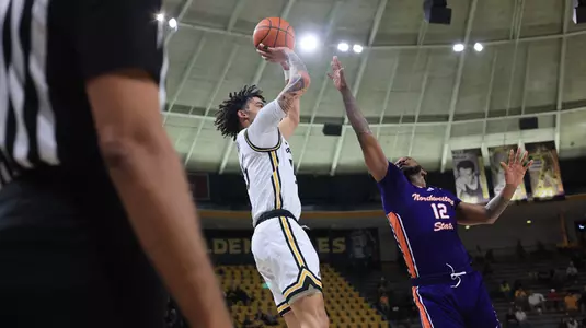 Southern Miss Golden Eagles guard Donovan Ivory (15) with a shot over Northwestern State Demons guard Jae Slack (12) in a game between the Southern Miss Golden Eagles vs South Northwestern State in the NCAA Basketball Game. December 9, 2023. (Joe Harper/bgnphoto.com)