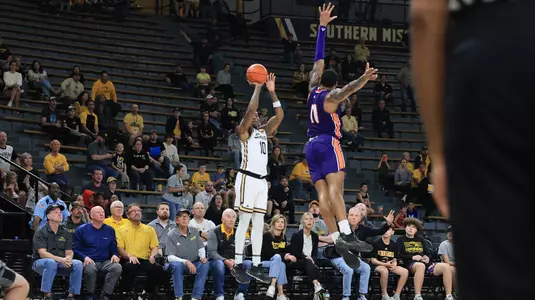 Southern Miss Golden Eagles guard Cobie Montgomery (10) shots a three over Northwestern State Demons forward Justin Wilson (11) in a game between the Southern Miss Golden Eagles vs South Northwestern State in the NCAA Basketball Game. December 9, 2023. (Joe Harper/bgnphoto.com)