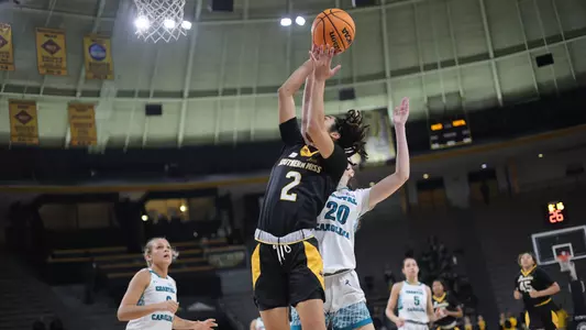 Southern Miss Lady Eagles guard Domonique Davis (2) drives the lane and gets past Coastal Carolina Chanticleers center Miriam Recarte (20) for the lay up in a game between the Southern Miss Golden Eagles and the Costal Carolina . February 10, 2023 (Joe Harper/bgnphoto.com)
