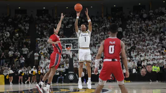 Southern Miss Golden Eagles guard Austin Crowley (1) shoots a three point basket in a game between the Southern Miss Golden Eagles and the Louisiana Ragin Cajuns . February 9, 2023 (Joe Harper/bgnphoto.com)