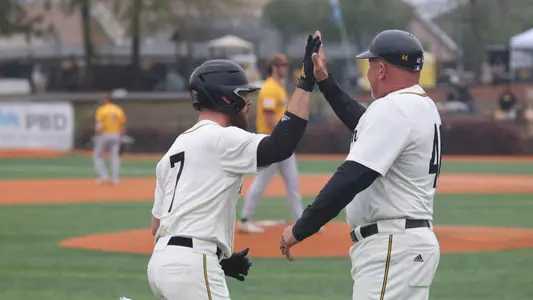 Southern Miss. outfielder Slade Wilks (7) gets a high five from Southern Miss head coach Scott Berry in a game between the Southern Miss Golden Eagles and Valparaiso. March 12, 2023 (Joe Harper/bgnphoto.com)