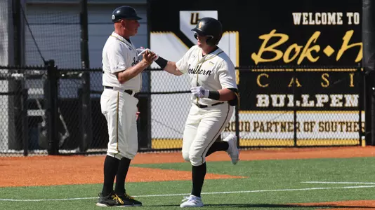 Southern Miss. first baseman Christopher Sargent (41) and Southern Miss head coach Scott Berry high five in a game between the Southern Miss Golden Eagles and Dallas Baptist University. March 5, 2023 (Joe Harper/bgnphoto.com)