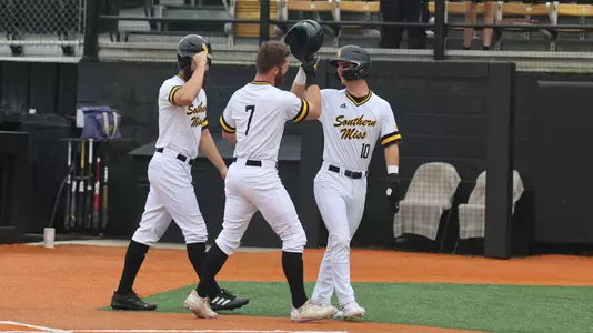 Southern Miss. outfielder Slade Wilks (7) is congradulated by Southern Miss. infielder Dustin Dickerson (10) and Southern Miss. outfielder Matthew Etzel (3) after his home run in a game between the Southern Miss Golden Eagles and James Madison Dukes. April 15, 2023 (Joe Harper/bgnphoto.com)