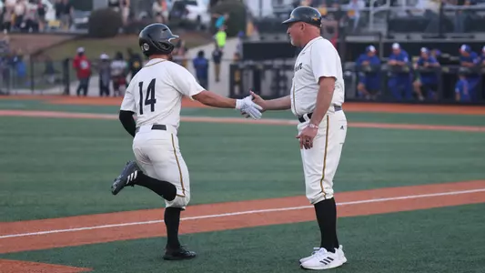 Southern Miss. outfielder Reece Ewing (14) and Southern Miss. head coach Scott Berry (40) celebrate the home run in a game between the Southern Miss Golden Eagles and La Tech Bulldogs. April 14, 2023 (Joe Harper/bgnphoto.com)