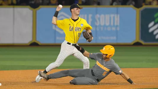 Southern Miss. infielder Dustin Dickerson (10) throws to first base as Tennessee outfielder Hunter Ensley (9) slides in in a game between the Southern Miss Golden Eagles and Tennessee Volunteers in the NCAA Super Regional Tournament. June 12, 2023 (Joe Harper/bgnphoto.com)