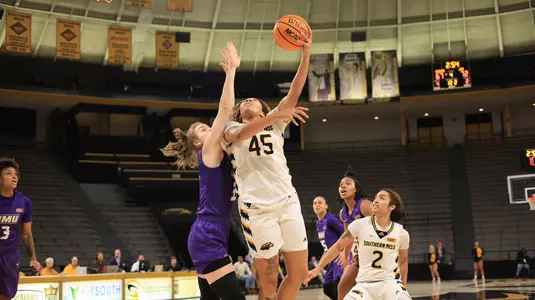 Southern Miss Lady Eagles center Melyia Grayson (45) with a layup over James Madison Dukes center Kseniia Kozlova (35) in a game between the Southern Miss Golden Eagles and the James Madison Dukes in a NCAA Women's Basketball game. January 11, 2024. (Joe Harper/bgnphoto.com)