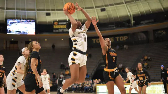 Southern Miss Lady Eagles guard Brikayla Gray (0) with a layup after the assist from Southern Miss Lady Eagles guard Domonique Davis (2) in a game between the Southern Miss Golden Eagles and the UL Monroe Warhawks in a NCAA Women's Basketball game. January 11, 2024. (Joe Harper/bgnphoto.com)