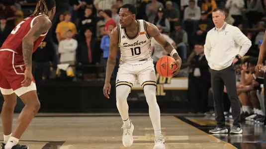 Southern Miss Golden Eagles guard Cobie Montgomery (10) brings the ball up the court in a game between the Southern Miss Golden Eagles and the Troy Trojans in a NCAA Men's Basketball game. January 20, 2024. (Joe Harper/bgnphoto.com)