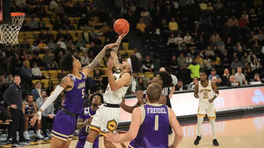 Southern Miss Golden Eagles guard Andre Curbelo (11) takes a shot over James Madison Dukes guard Terrence Edwards Jr. (5) in a game between the Southern Miss Golden Eagles and the James Madison Dukes in a NCAA Women's Basketball game. January 01, 2024. (Joe Harper/bgnphoto.com)