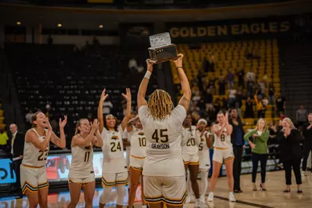 Melyia Grayson (45) hoists the Mayor's Cup