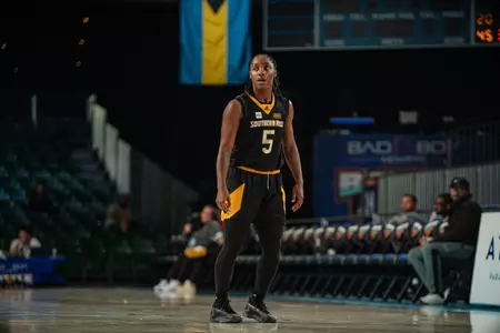 Bre Sutton (5) drives to the basket against Baylor