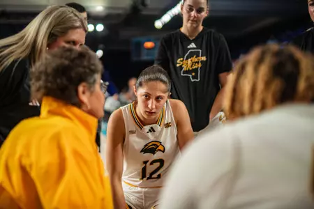 Morgan Sieper (12) listens to Joye Lee-McNelis in a timeout