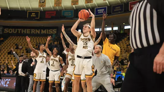 Southern Miss Golden Eagles guard Tate Ryder (55) drains a big three point shot as the team looks on in a game between the Southern Miss Golden Eagles and the Western Michigan Broncos in a NCAA Men's Basketball game. February 10, 2024. (Joe Harper/bgnphoto.com)