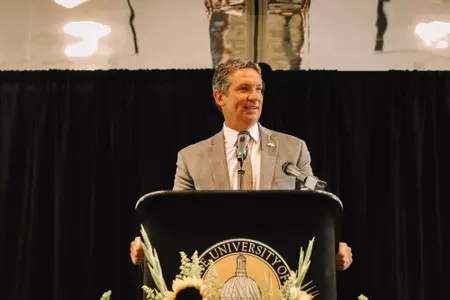 Jeremy McClain at the podium at Christian Ostrander's head coaching announcment