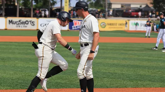 Southern Miss. outfielder Carson Paetow (37) congratulated by assistant coach Travis Creel after the home run in a NCAA Baseball game between the Southern Miss Golden Eagles and the Coastal Carolina. May 4, 2024. (Joe Harper/bgnphoto.com)