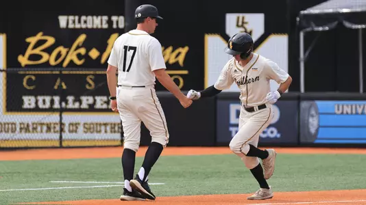 Southern Miss. infielder Ozzie Pratt (4) is congratulated by assistant coach Travis Creel after the home run in a NCAA Baseball game between the Southern Miss Golden Eagles and the Coastal Carolina. May 4, 2024. (Joe Harper/bgnphoto.com)