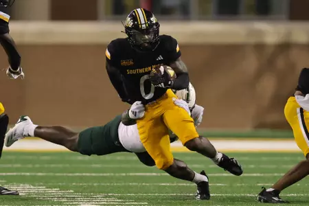 Southern Miss Golden Eagles running back Derek Clark (0) tries to break a tackle to pick up additional yardage in a NCAA football game between the Southern Miss Golden Eagles and the South Florida Bulls. September 14, 2024. (Joe Harper/bgnphoto.com)
