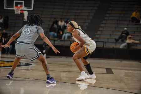 Nyla Jean (14) holds the ball against Old Dominion