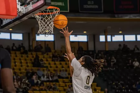 Micah Cooper (0) drives to the basket against South Alabama