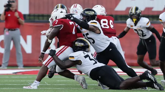 Southern Miss Golden Eagles linebacker Chris Jones (35) and Southern Miss Golden Eagles defensive tackle Brodarius Lewis (36) bring down Louisiana-Lafayette Ragin Cajuns running back Bill Davis (7) In a game between Southern Miss and Louisiana and in the NCAA Football game. October 18, 2025 (Joe Harper/bgnphoto.com)
