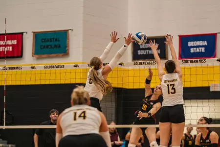 Sadie McAda (6) and Lillie Johnson (13) blocking vs. ULM