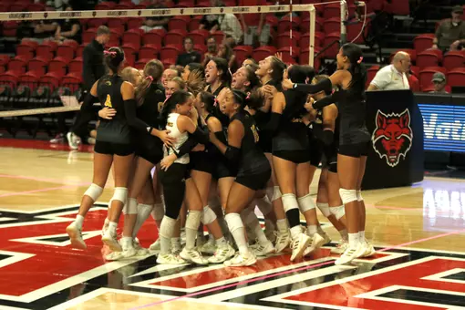 Volleyball celebrates a 5-set win against Arkansas State on Oct. 4th in Jonesboro.