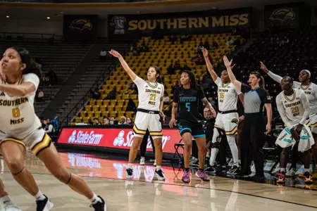 Carly Keats (21) hits a three in front of the Lady Eagle bench against Blue Mountain Christian