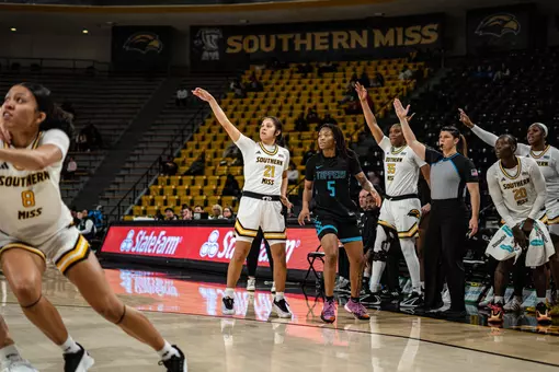 Carly Keats (21) hits a three in front of the Lady Eagle bench against Blue Mountain Christian