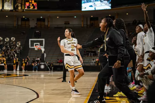 Carly Keats hits a three in front of Southern Miss' bench