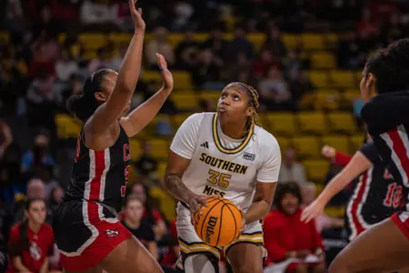 Whitney Hart eyes the basket against William Carey