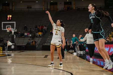 Meloney Thames hits a three-pointer against Coastal Carolina
