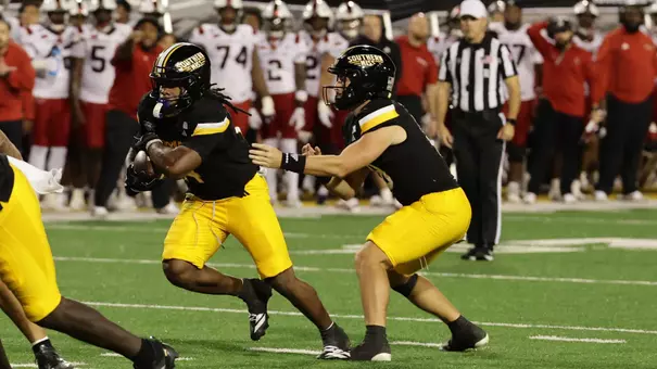Southern Mississippi Golden Eagles quarterback Landry Lyddy (18) hands the ball off to Southern Mississippi Golden Eagles running back Steven Robinson (14) in a NCAA Football game between Southern Miss Golden Eagles and Arkansas State Red Wolves at Carlisle-Faulkner Field at Renasant Stadium. October 17, 2026 (Joe Harper/bgnphoto.com)