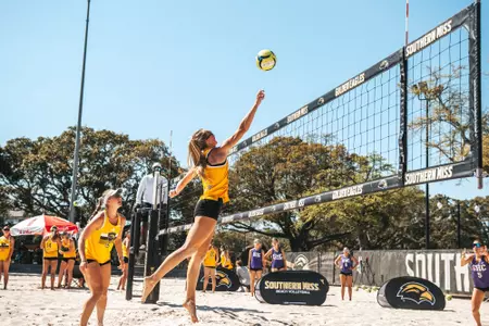 Sadie McAda (15) watches Laurel Dennis (4) attack the net