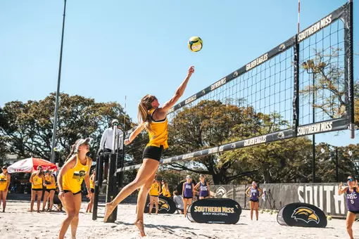 Sadie McAda (15) watches Laurel Dennis (4) attack the net